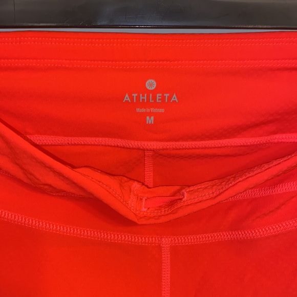 Athleta NWOT orange, thin leggings with side pockets, zip packet size Medium - Picture 7 of 7